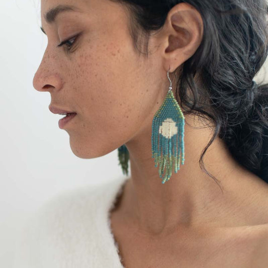 Beaded fringe earrings modeled on a woman.