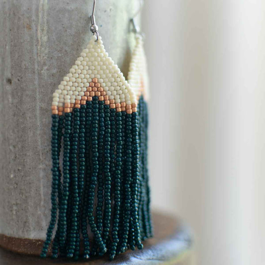 Beaded earrings with geometric design on a neutral background