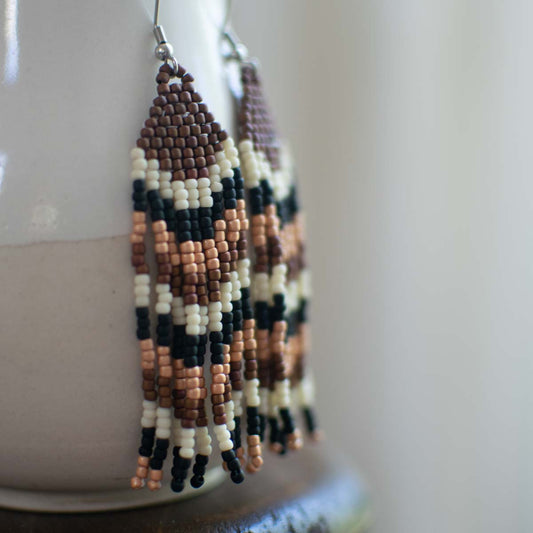 Beaded earrings with a geometric pattern on a white surface