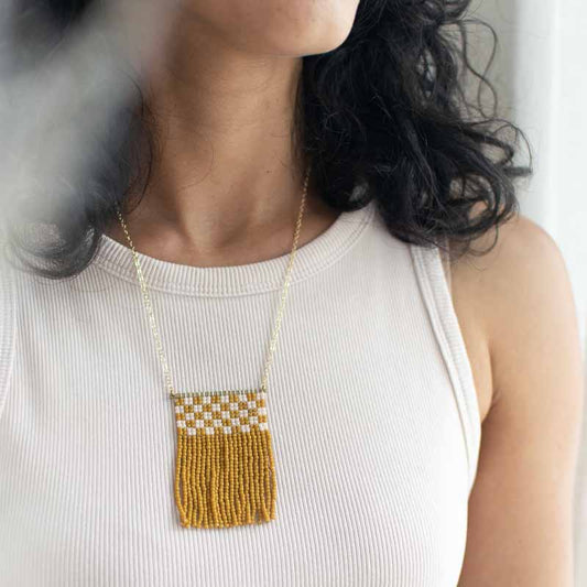 Minimal beaded fringe necklace modeled on a woman.