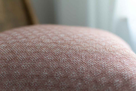 Close-up of a textured fabric surface with a blurred background