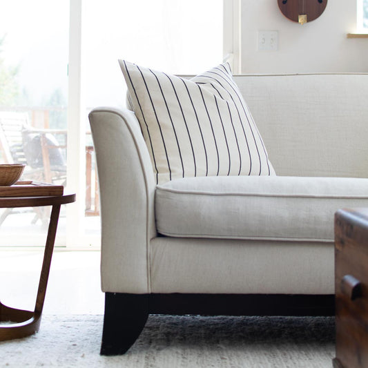 striped pillow on beige couch