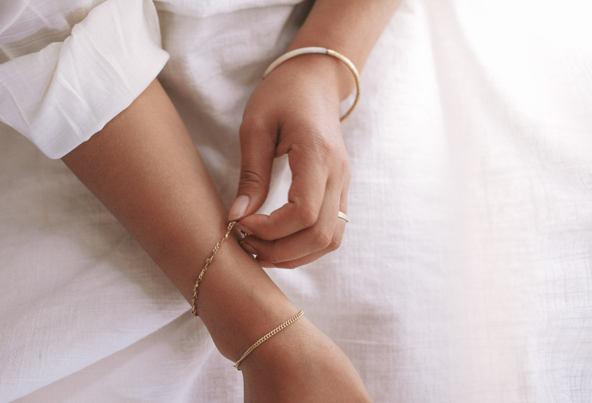hands with bracelets holding pampass