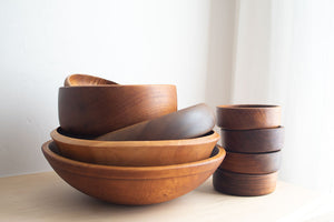 Stack of antique wooden bowls with words 01 Restored