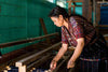 artisan preparing threads for pedal loom