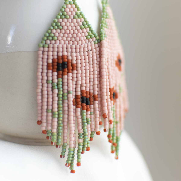 Woven seed bead earring with floral design.