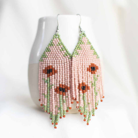 Beaded earring with poppy flower design.