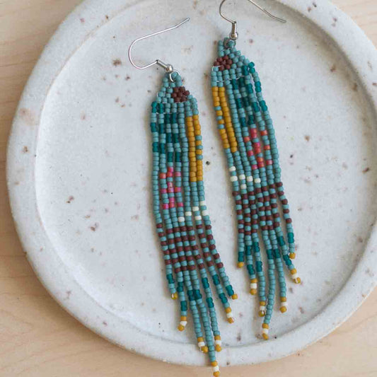 Beaded earrings on a textured ceramic plate