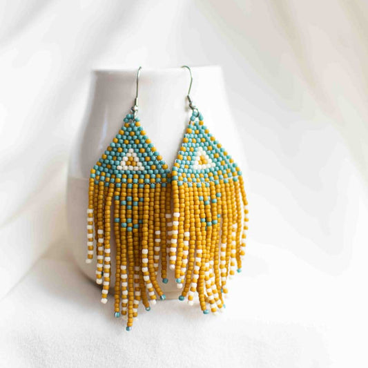 Beaded earrings with turquoise, mustard yellow, and beige accents including a triangle.