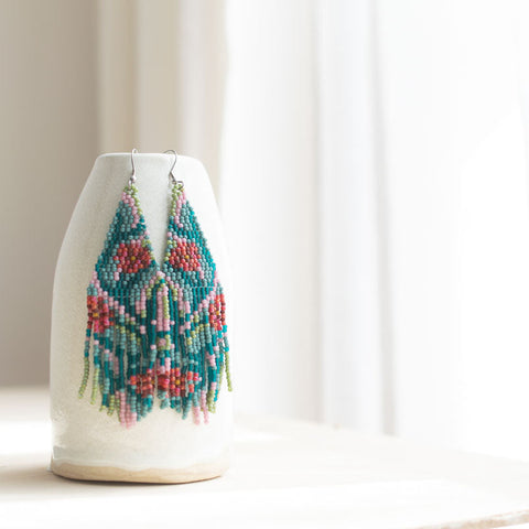 Fair trade beaded earrings with floral patterns on a white background
