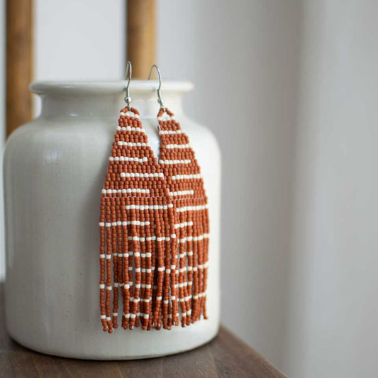 Beaded earrings in terra cotta stripes.