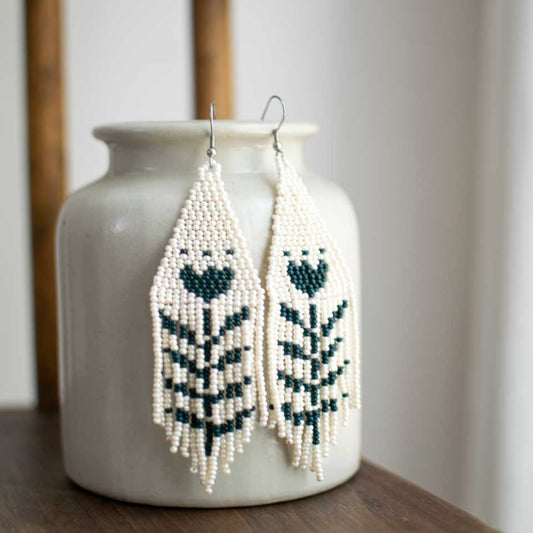 Beaded earrings with green flower design.