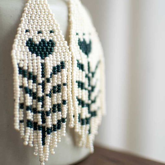 Seed bead earring closeup of weaving and fringe.
