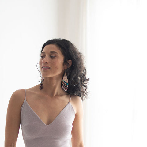 Woman wearing a light purple dress with a plain white background