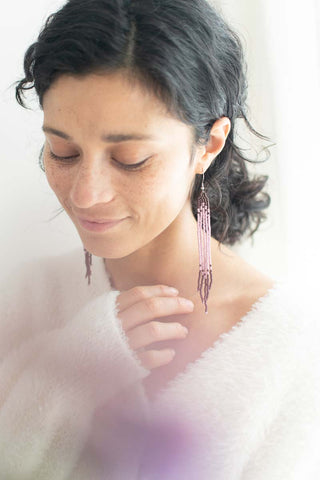 women wearing purple and lavender beaded earrings