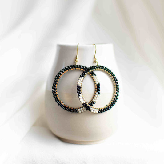 Beaded hoop earrings in black and white.