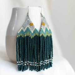 Beaded earring with mountain design.