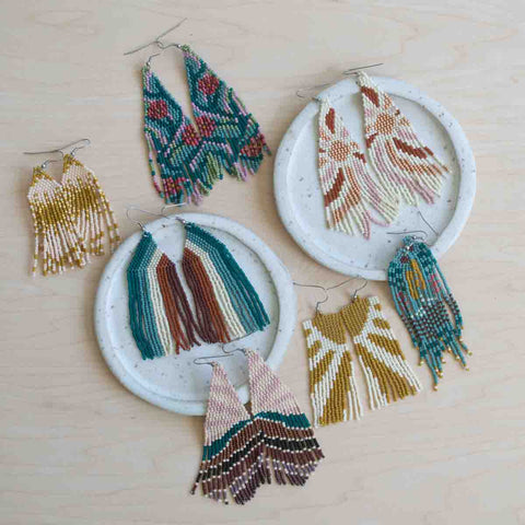 Spring Summer Collection of beaded earrings on a wooden surface