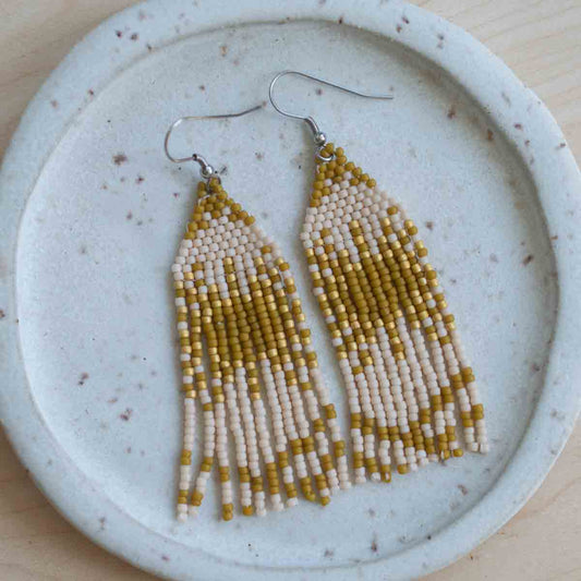 Beaded earrings on a textured ceramic plate