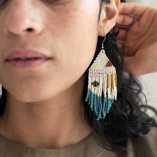 Beaded fringe earrings with simple design modeled on a woman.