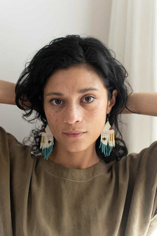 woman wearing fair trade woven earrings