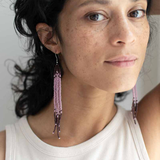 women wearing minimal beaded earrings