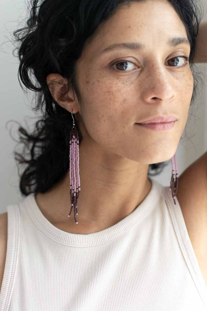 women wearing minimal beaded earrings