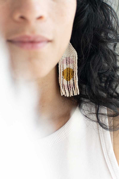 women wearing simple woven earrings