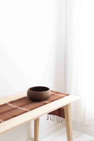 simple table runner on table with wooden bowl