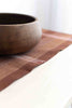 handwoven table runner closeup pictured with wooden bowl