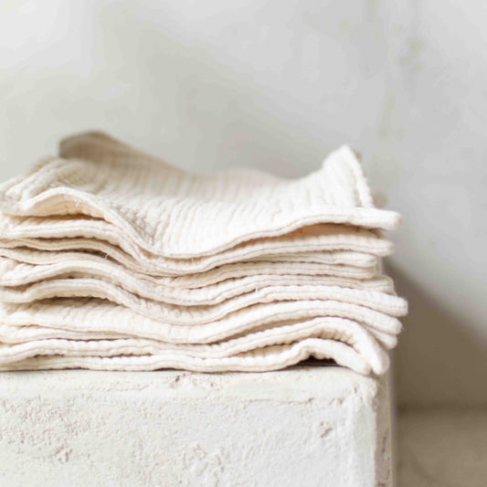 Stack of organic cotton gauze wash cloths.
