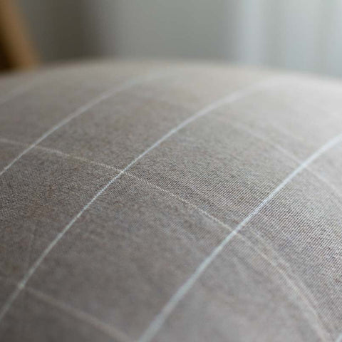 Close-up of a textured fabric surface with a grid pattern.