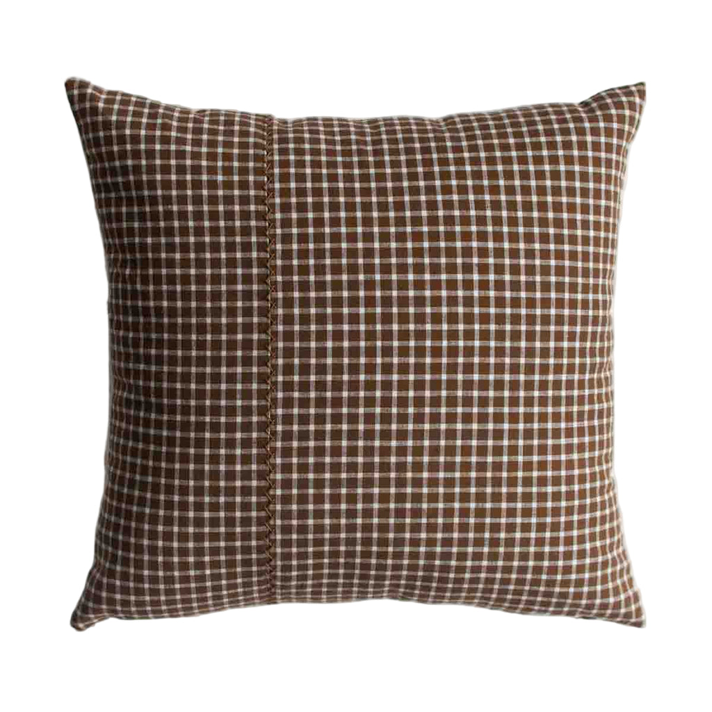 Checkered pillow with brown and white pattern on a white background