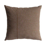 Checkered pillow with brown and white pattern on a white background