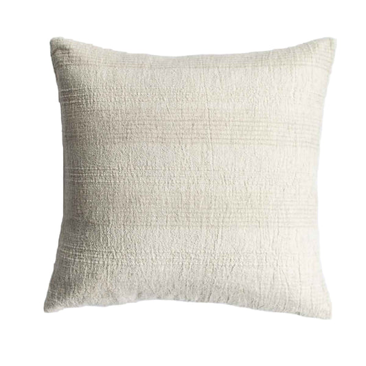 Textured beige pillow on a white background