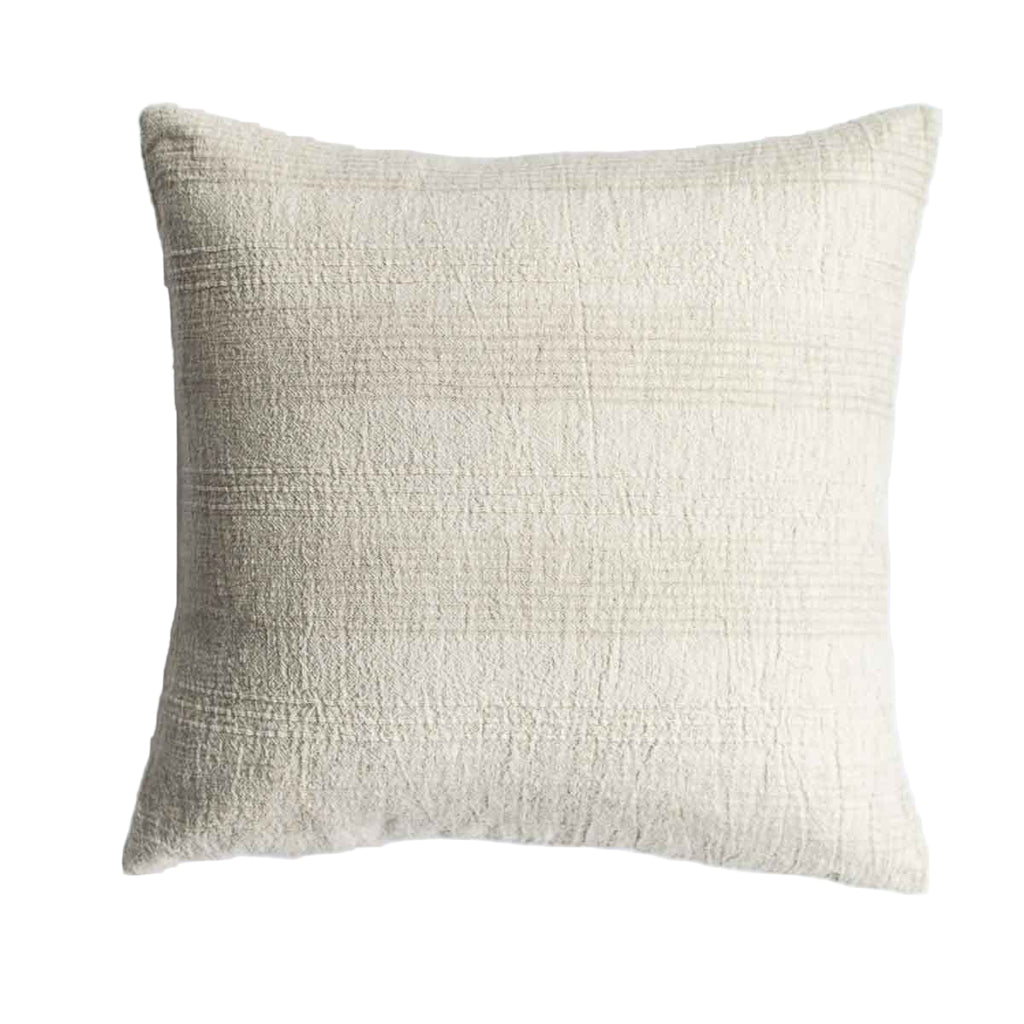 Textured beige pillow on a white background