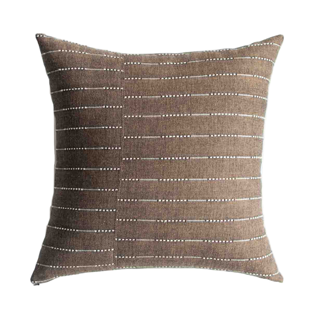 Brown pillow with white line pattern on a white background