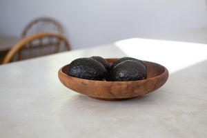 Small wooden bowl with avocados