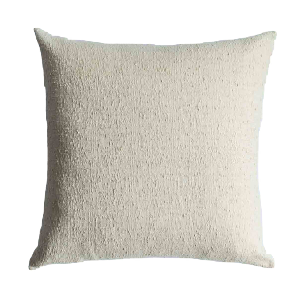 Textured beige pillow on a white background