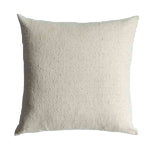 Textured beige pillow on a white background