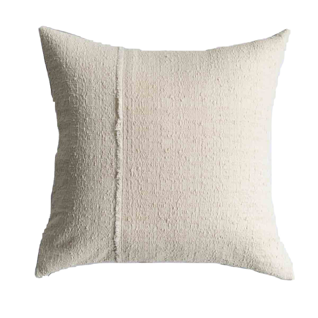 Textured beige pillow on a white background