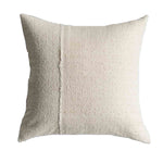 Textured beige pillow on a white background