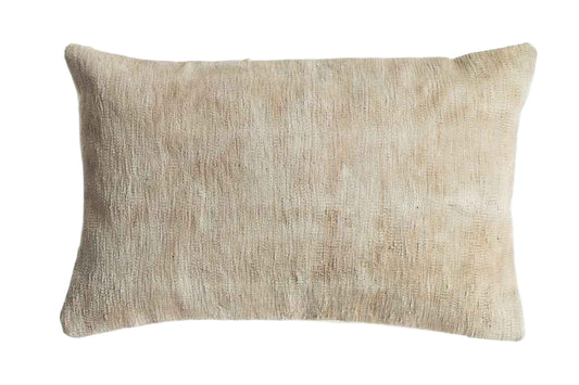 Beige textured pillow on a white background