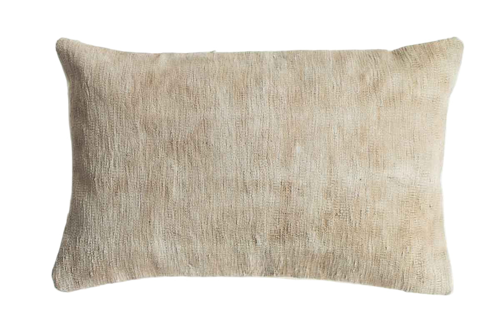 Beige textured pillow on a white background