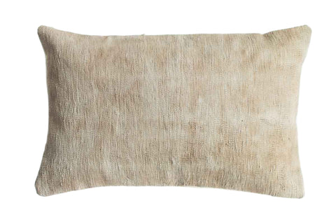 Beige textured pillow on a white background