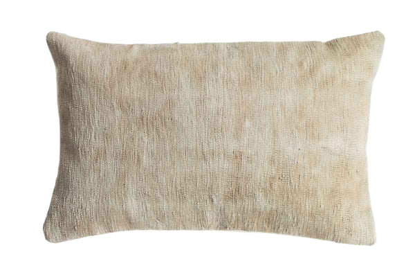 Beige textured pillow on a white background