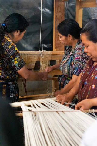 Kaqchikel Mayan women set up pedal loom