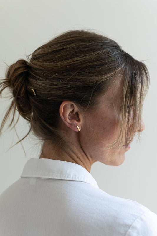 woman wearing minimalistic fair trade earrings