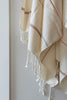 handwoven striped textile with fringe