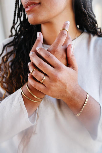 woman wearing minimalistic fair trade jewelry